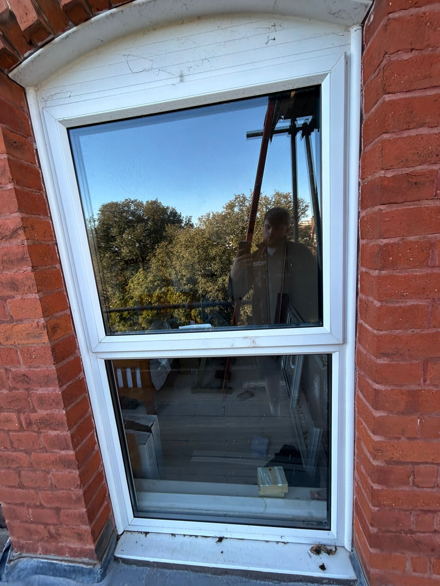 Sash window in brick arch exterior