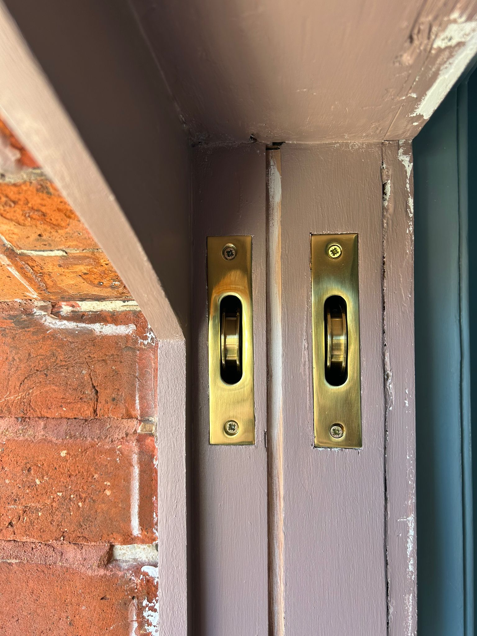 Brass sash pulley ironmongery close-up